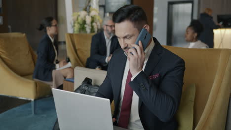 businessman on the phone in hotel lobby
