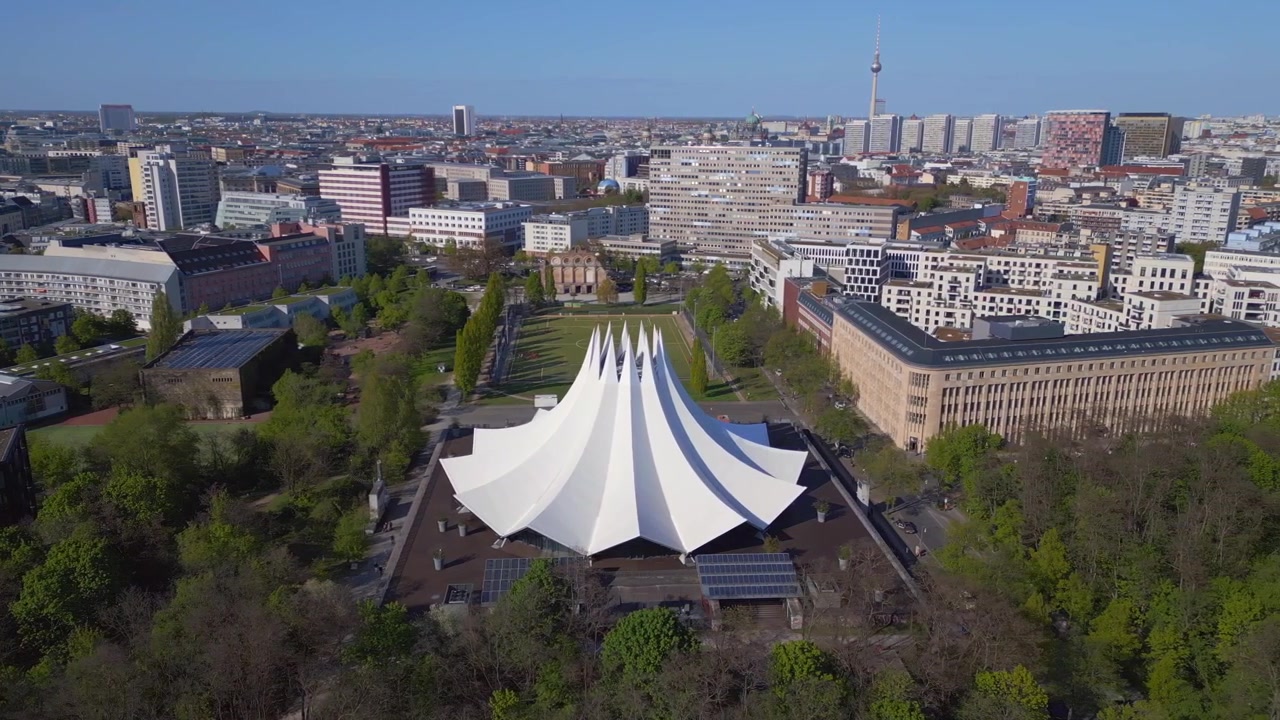 Lovely aerial top view flight Berlin Tempodrom white tentroof of concrete building, City district Kreuzberg, Germany spring 2023. boom sliding to right drone
4k uhd cinematic footage.