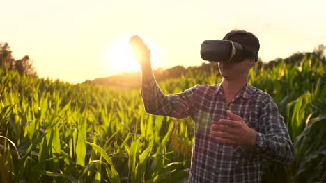 smart farming with iot futuristic agriculture concept : farmer wears vr or ar glasses while monitoring rainfall temeprature humidity soil ph with immersive experience on digital holographic screen.