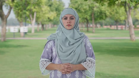 angry muslim woman looking at the camera in park