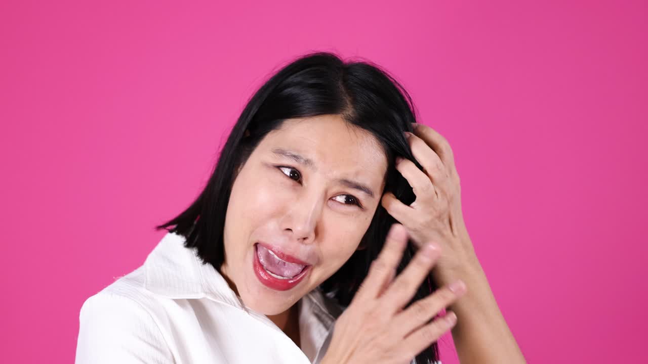 Asian woman in white shirt displays surprised, shocked emotions with animated facial expressions, studio lighting