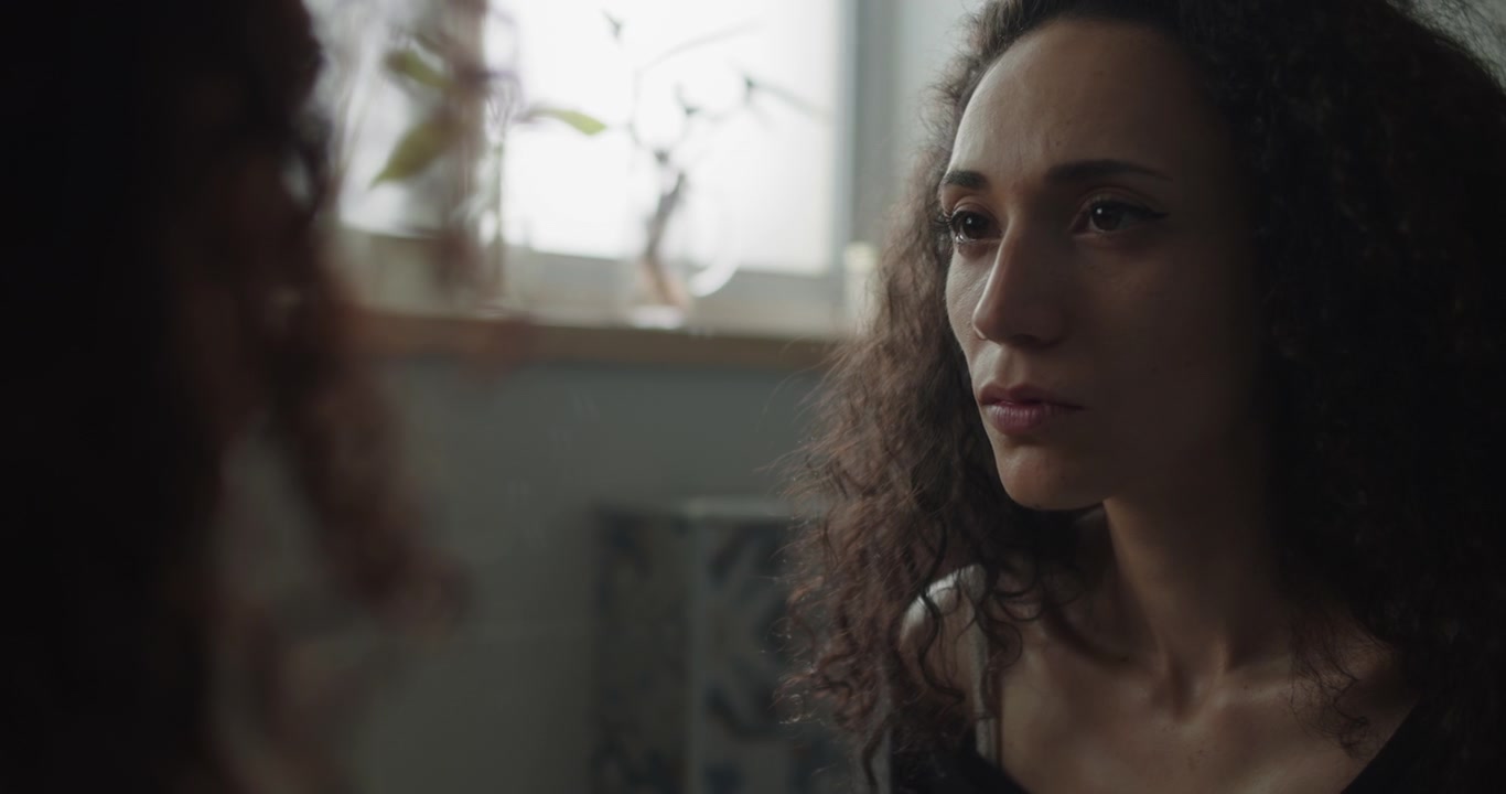 Insecure woman staring at her reflection