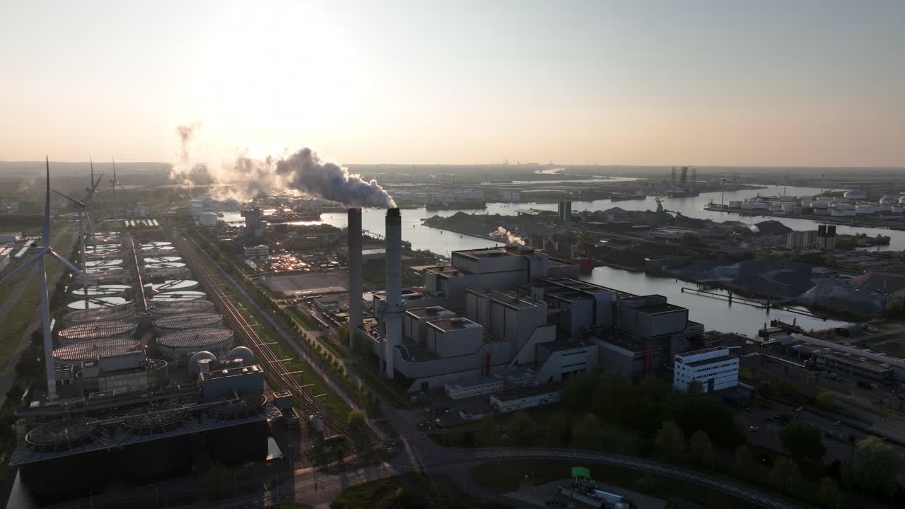 Massive waste incinerator, smoke plums, sky view. Aerial view. waste incineration plant, sunset. Aerial view.