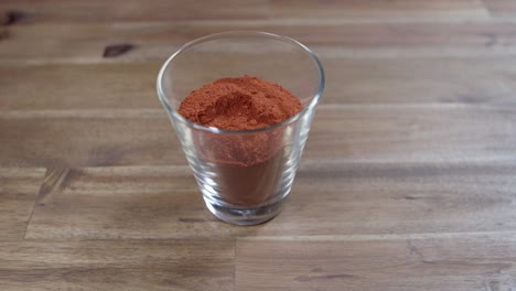 Paprika-powder-in-a-small-glass-container,-essential-ingredient-for-the-preparation-of-Argentine-chimichurri