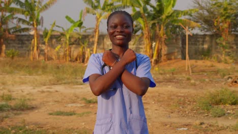 africa female nurse doctor saying i love you with gesture sign language in front of camera happily smiling