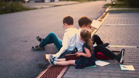 students in shirts play near young sister after lessons