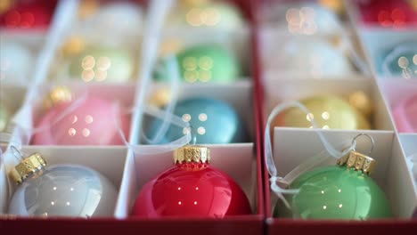 foreground view of vibrant holiday ornaments stored in a box