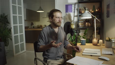 man recording podcast in evening at home