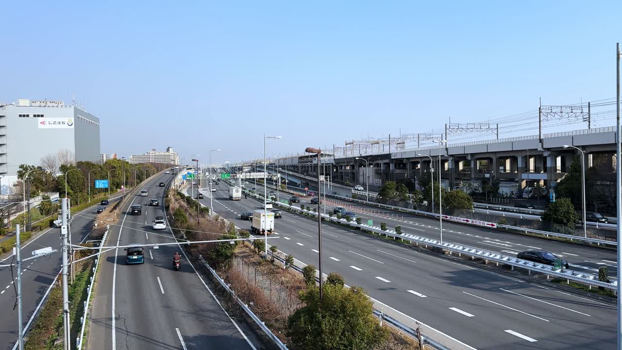 Modern highway with cars and trains running in Tokyo, Japan, bright sunny day