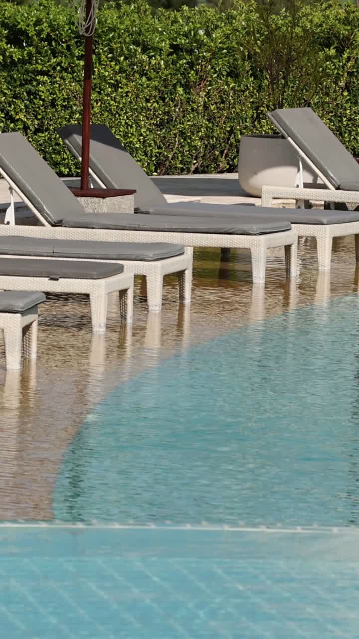 Poolside loungers by a tranquil swimming pool