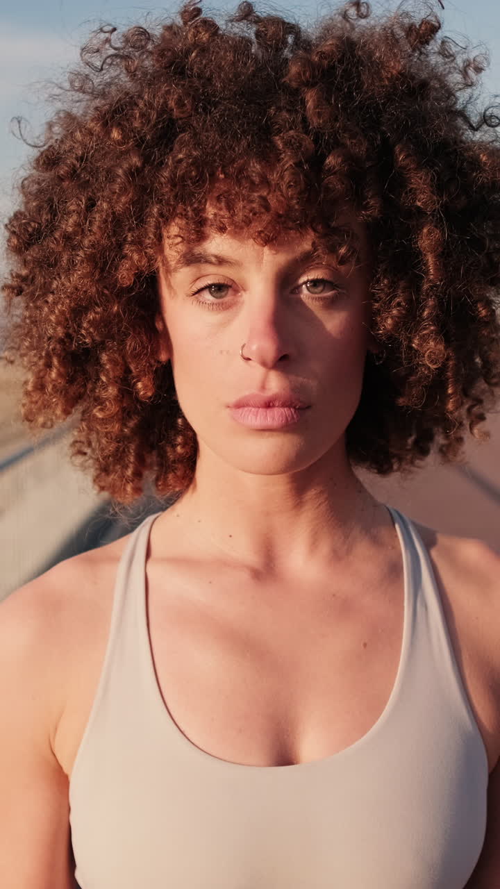 Confident Woman on Boardwalk by Beach
