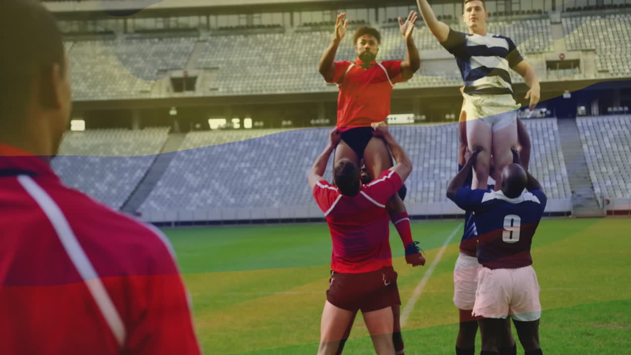 Rugby players jumping in lineout, catching ball on stadium field