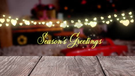 Animation-of-seasons-greetings-text-and-hanging-fairy-lights-against-decorated-christmas-house