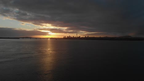 aerial view over waitemata harbour at sunrise of auckland cityscape, new zealand