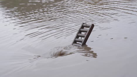 water from a flooded city street spiral down a recently cleared clogged drain