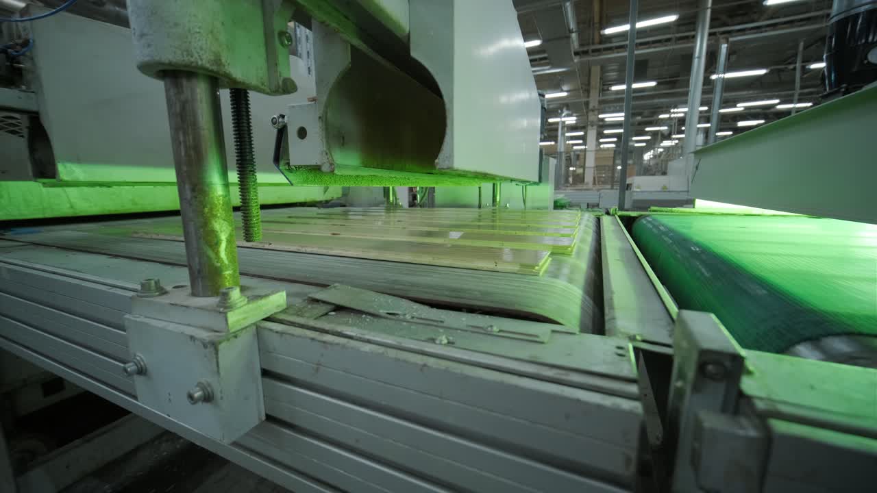 Industrial Machine Processing Wooden Planks on Conveyor Belt