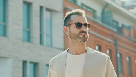 man in a beige jacket, sunglasses