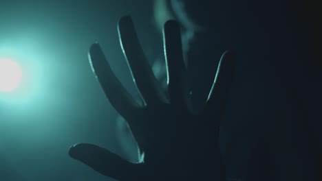hand in silhouette of girl pointing to camera