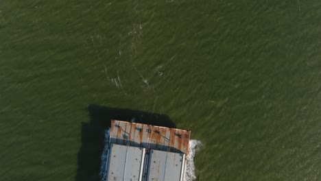 aerial establishing shot of large tanker boat in water