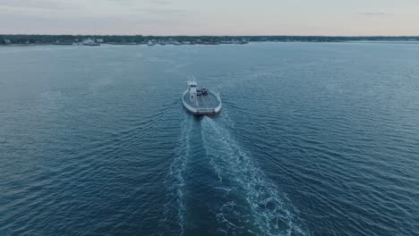 Top-Down-Aerial-Drone-shot-of-Ferry-departing-Shelter-Island-heading-towards-Greenport-North-Fork-Long-Island-New-York-before-sunrise