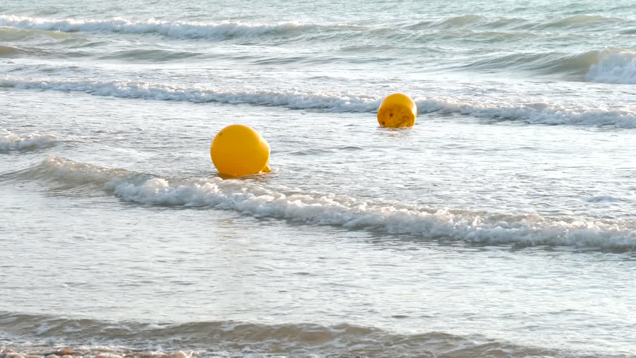 Yellow buoys floating in the mediterranean sea