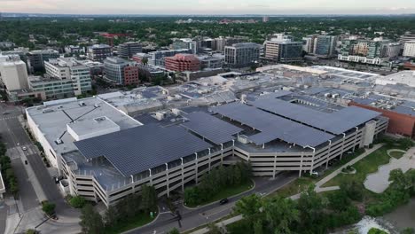 wide shot of large mall in america with parking garage with solar panel roof