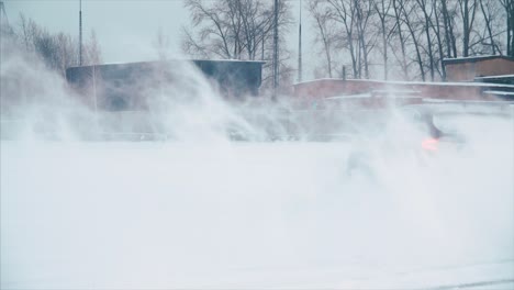 car driving in a heavy snowstorm