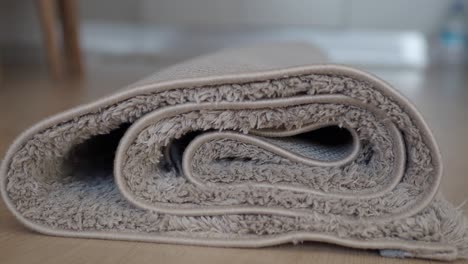 close-up of a rolled-up beige rug