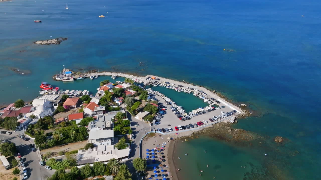 Drone rotating away from the Faliraki harbor, sunny day in Rhodes, Greece