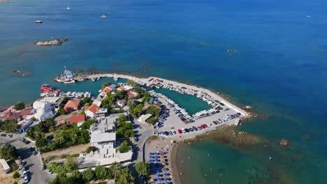 Drone rotating away from the Faliraki harbor, sunny day in Rhodes, Greece