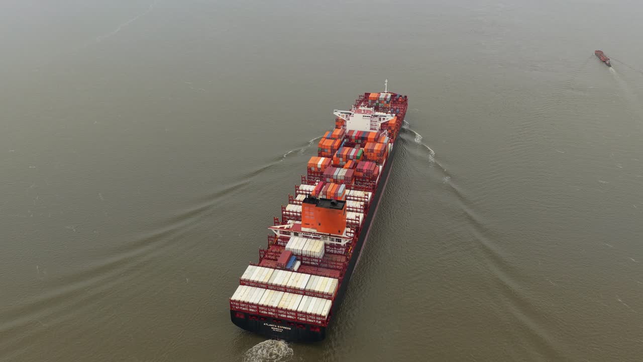 Container vessel seen from above transporting goods across open ocean
