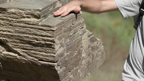 Archeologist checks rock for ancient engravings