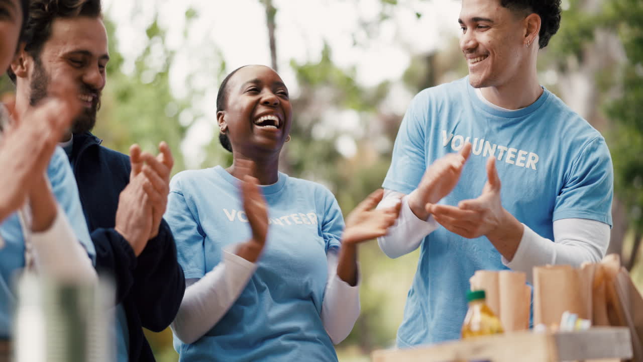 Happy Diverse Volunteers Clapping and Smiling Together Outdoors