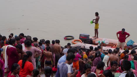 large crowd bathing in a river