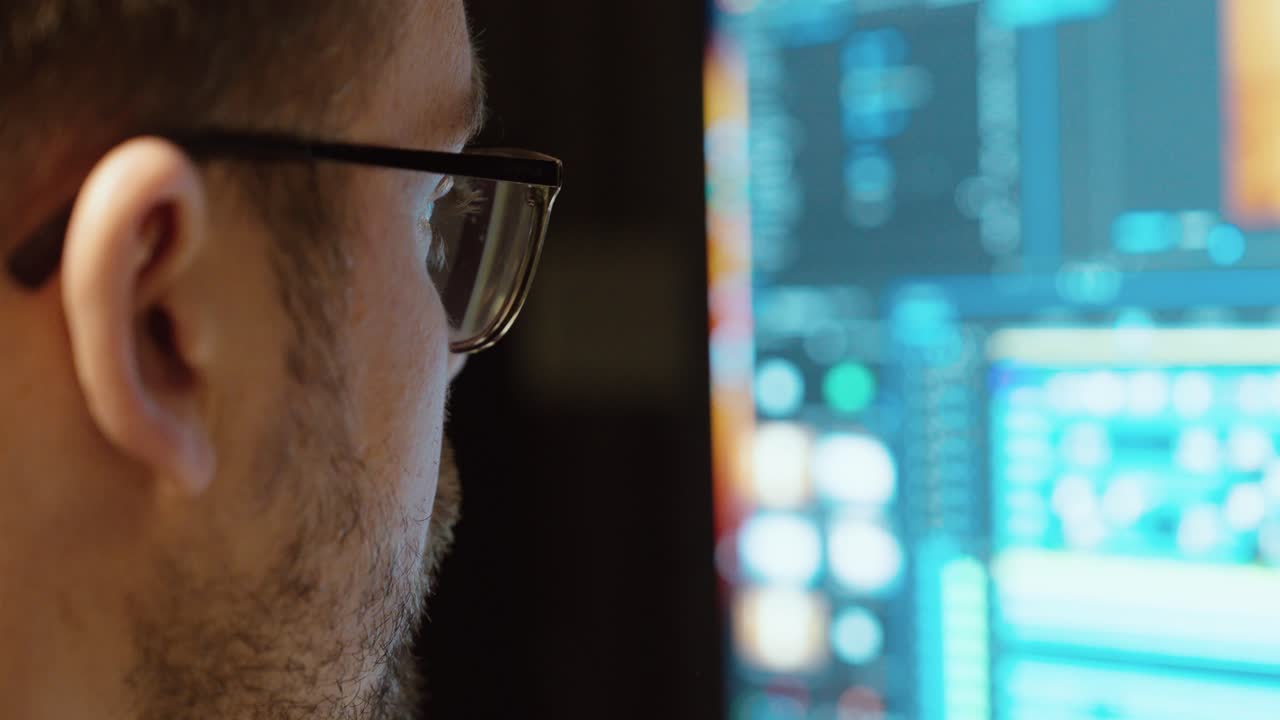 A professional video editor concentrates on editing footage in Adobe Premiere Pro. Concept of post-production, creativity, and modern filmmaking