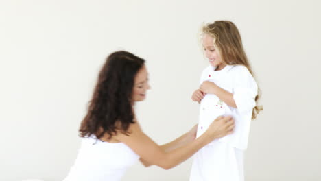 mother tickles her daughter