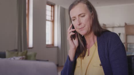 woman talking on smartphone at home