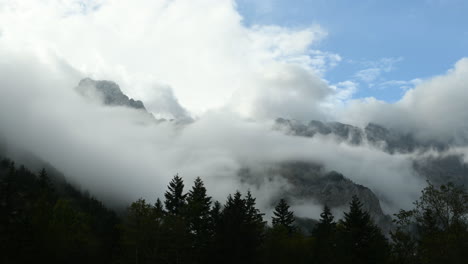 Time-lapse-of-clouds-over-mountain-peak,-dramatic-stormy-sky,-forest-in-foreground,-Ojstrica-peak-in-Kamnisko-Savinjske-Alpe,-Logarska-dolina,-Slovenia,-European-Alps