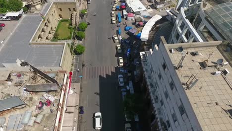 an aerial shot of the city of erbil showing the ancient erbil citadel and the garden opposite the castle with water fountains and the popular market