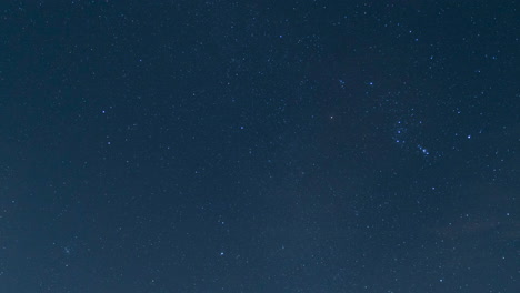 wispy clouds fly between earth and and the heavenly stars in this nighttime time lapse