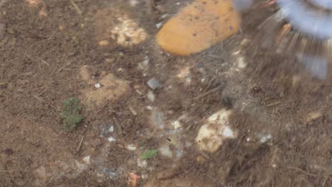 hand picking up an earthworm from a puddle, macro shot very close view