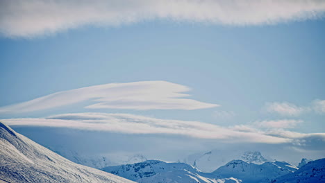 Timelapse-of-cycle-of-cloud-formation-on-a-white-mountain-background,-still-shot