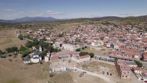 aerial view orbiting navas del rey scenic church suburbs in the community of madrid, spain