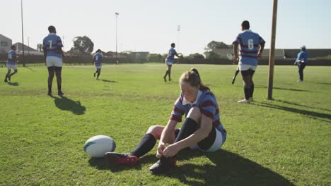 young adult female rugby player on a rugby pitch