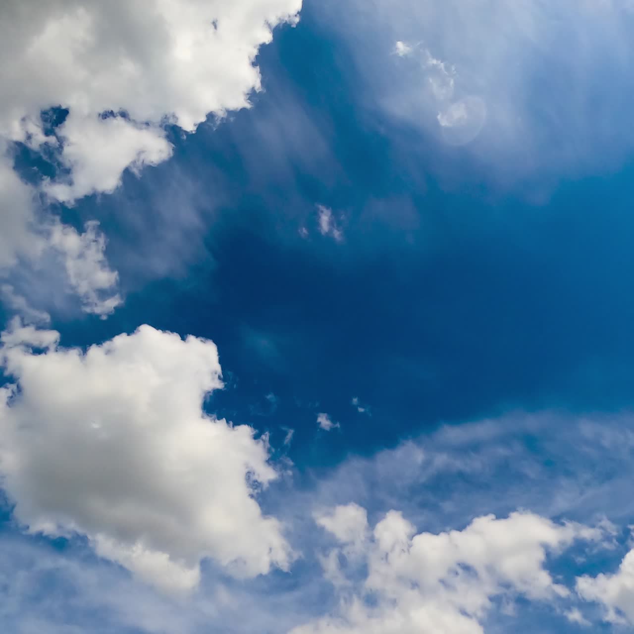 Cotton cloudscape gathering in the sky. Timelapse. Beautiful blue skyline on fantastic sunny day