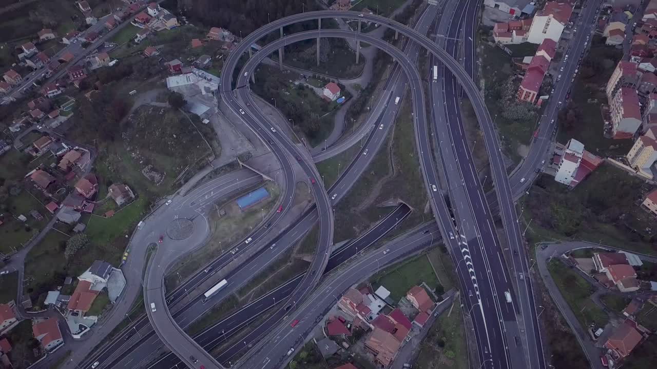 Aerial approach to a highway intersection construction in a rural area at sunset in Spain