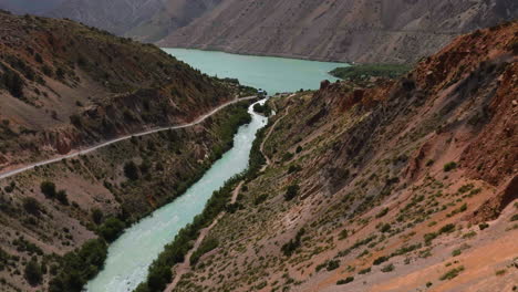 flying towards iskanderkul massive mountain lake in gissar range, fann mountains in tajikistan, central asia