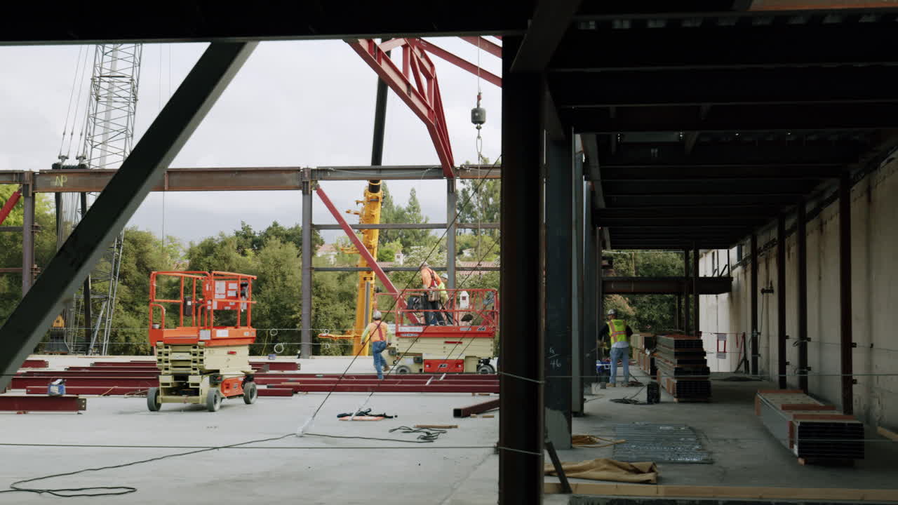 Construction Workers Erecting Steel Beams for a New Building