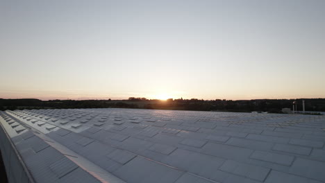 Low-Level-Aerial-View-of-Modern-Greenhouse-Producing-Agricultural-Crops---Dolly-Shot