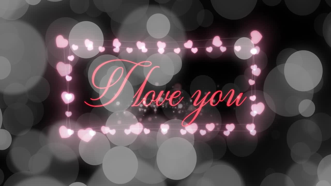 Animation of i love you text over hearts and spots